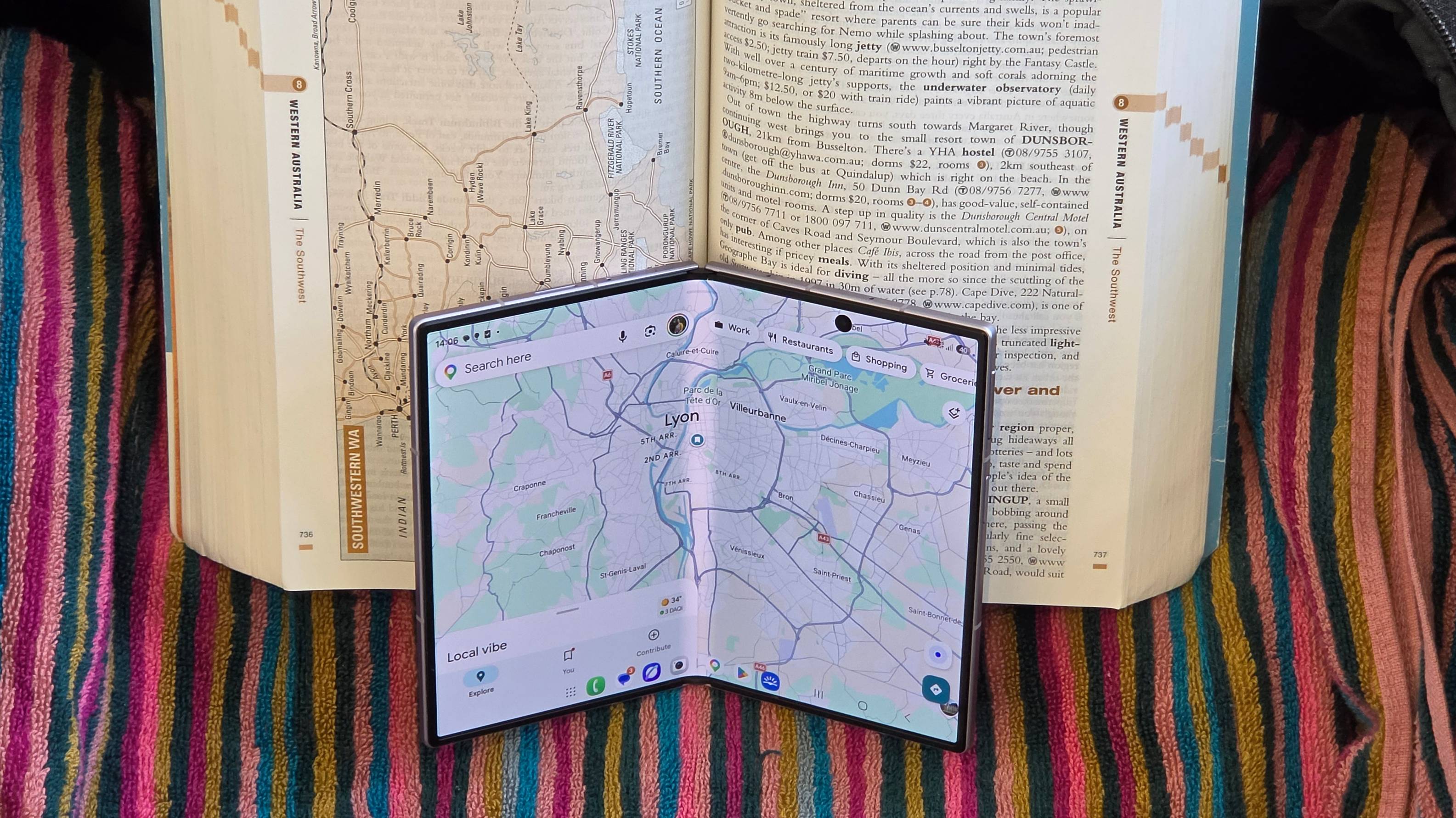 The Samsung Galaxy Z Fold 8 mostly-unfolded inside an unfolded book.