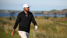 Scottie Scheffler walks off the green