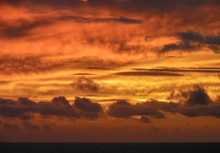 A golden sun sets over the East China Sea, near Okinawa, Japan.