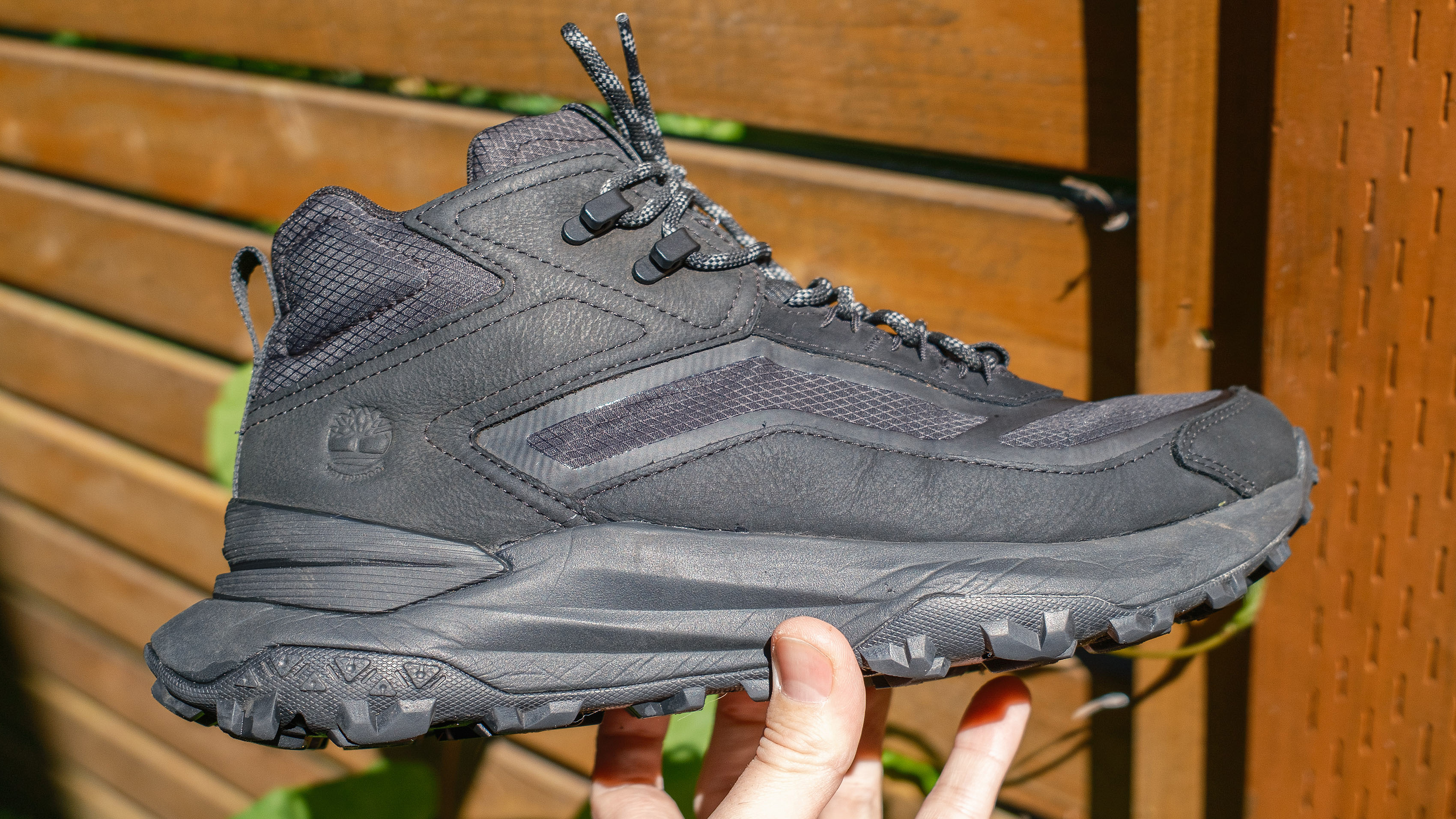 Close-up of the side of the Timberland Motion Access Mid Waterproof Sneakers (shown in black) in the reviewer's hand