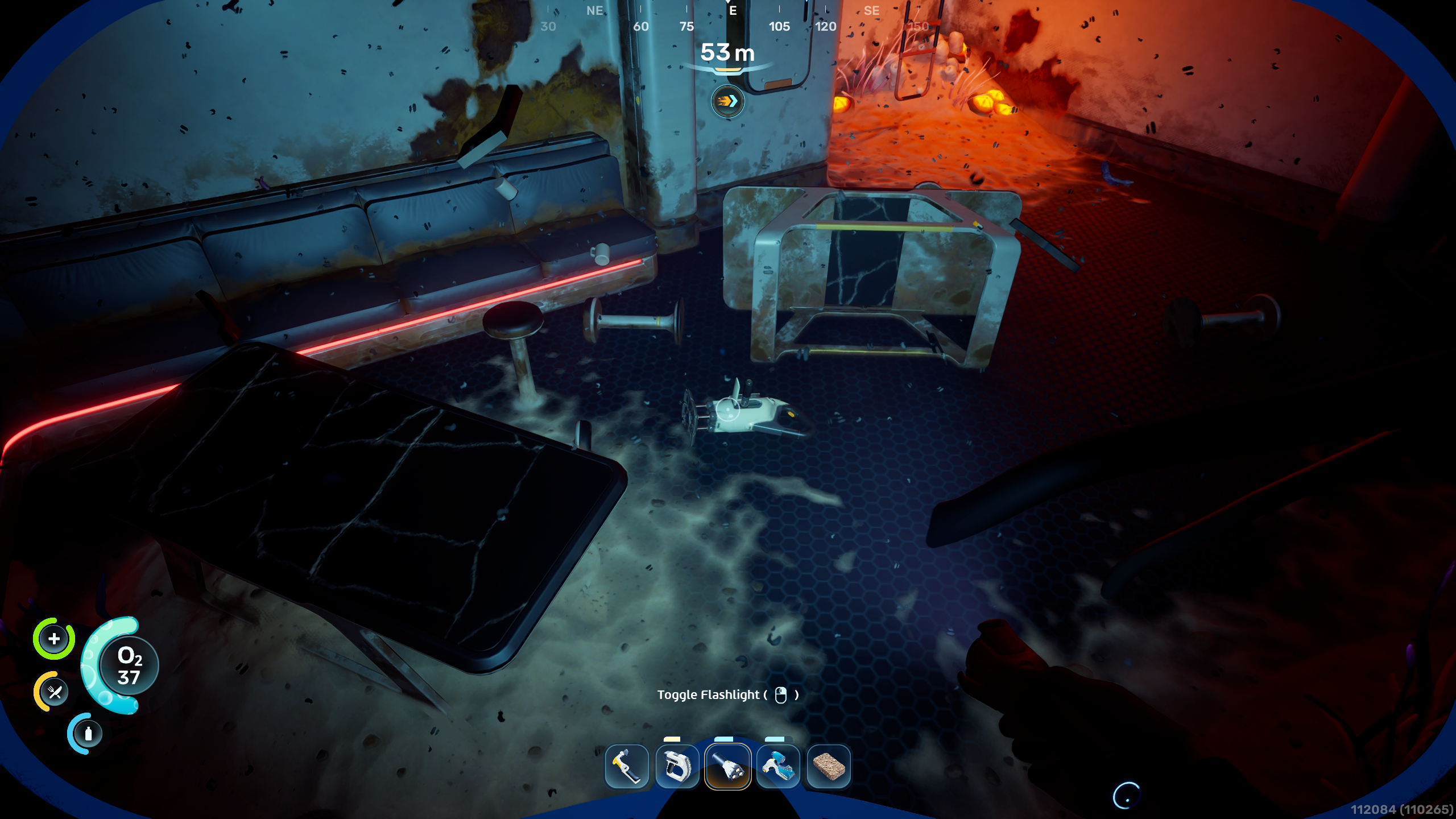 Subnautica 2 mining: A player looking at a Sonic Resonator fragment they can scan inside a dark habitat.