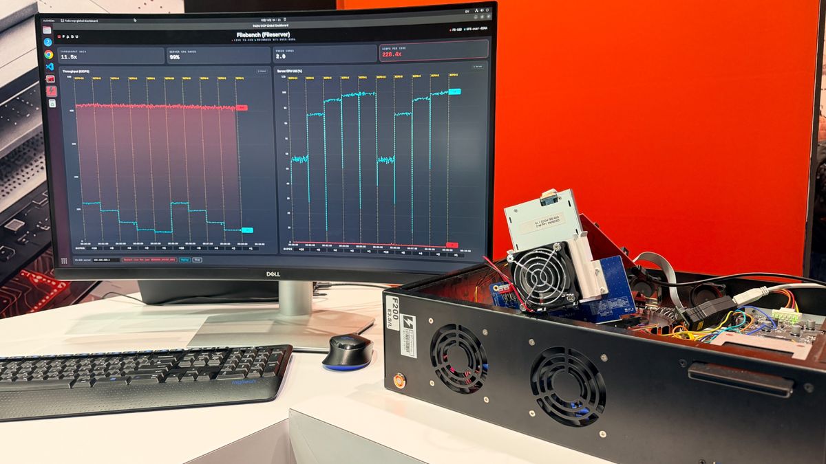 A curved monitor at FADUrsquo;s OCP Global Summit booth shows a Filebench dashboard comparing a live FS-SSD run with a recorded NFS-over-RDMA run, beside an open test chassis with an SSD mounted on a riser