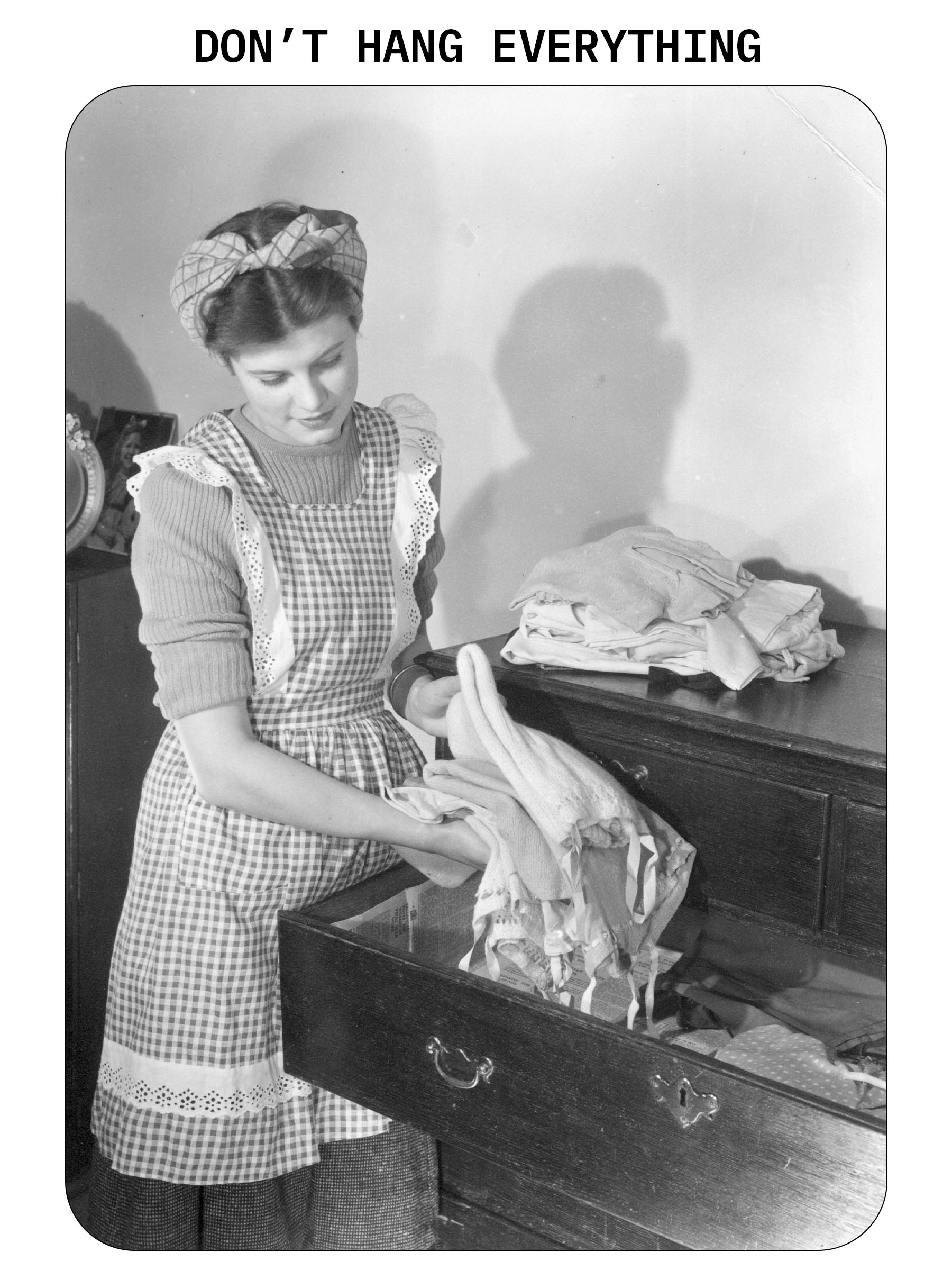 Vintage image of a woman putting away clothes in a drawer.