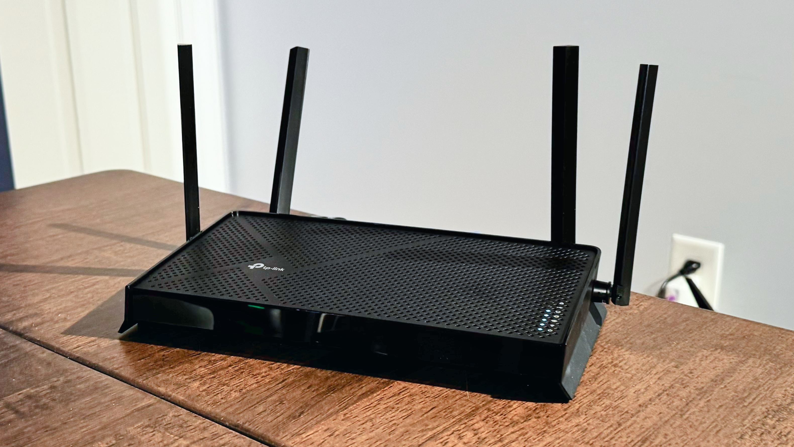 The TP-Link Archer BE3600 set up and on a desk.
