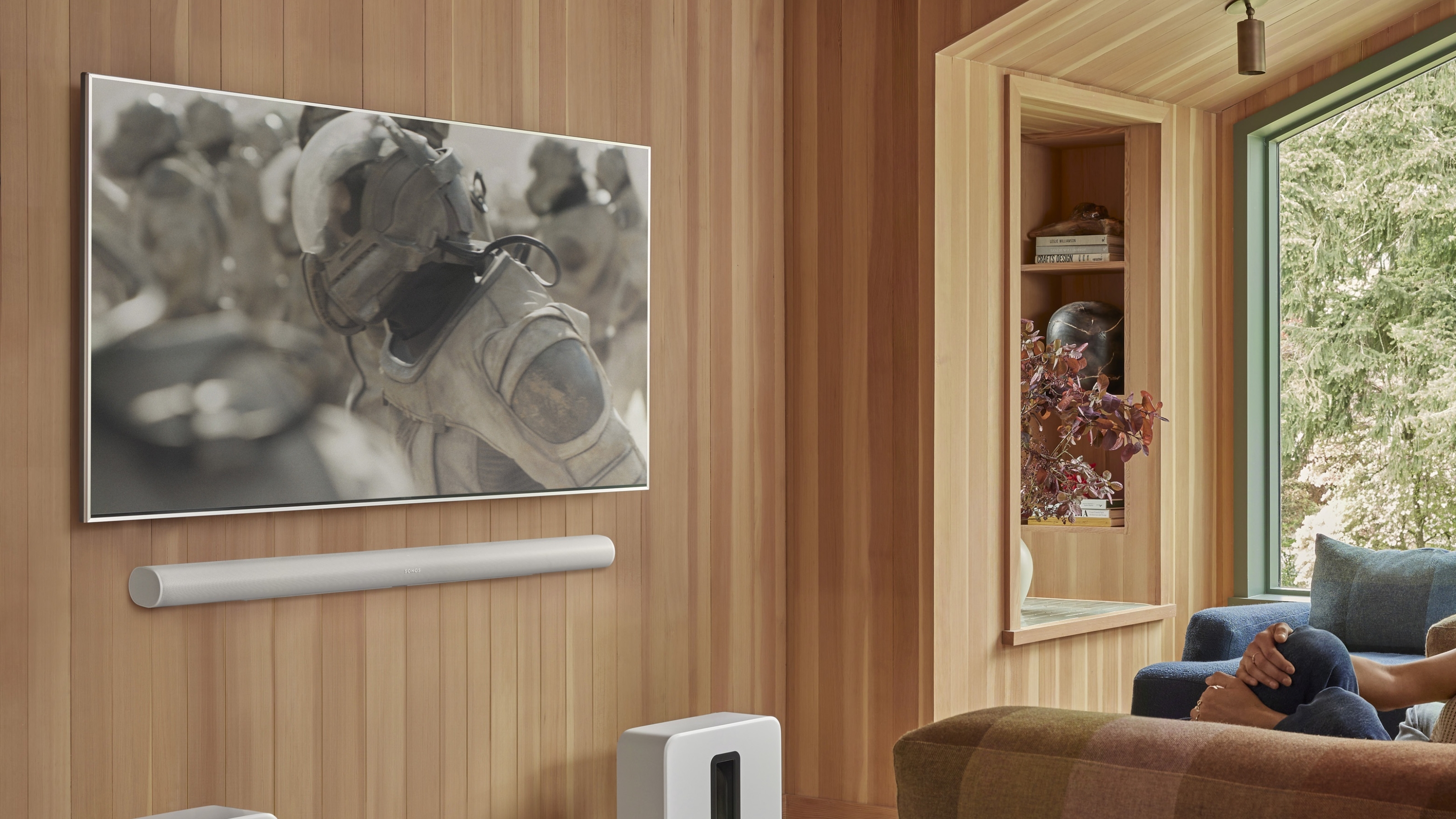 a tv in a modern living room with a soundbar underneath