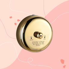 brass retractable clothes line on a pink graphic background