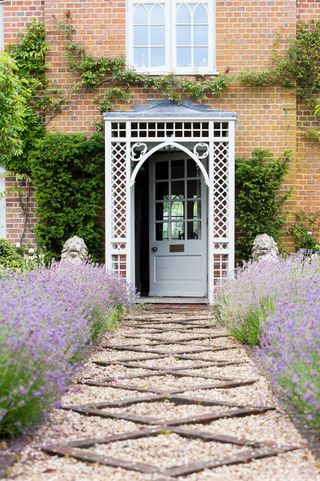 decorative gravel pathway lined with lavender leading to front door