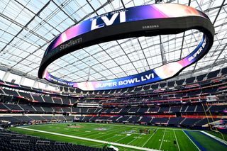 Workers prep the field at SoFi Stadium in Los Angeles for Super Bowl LVI