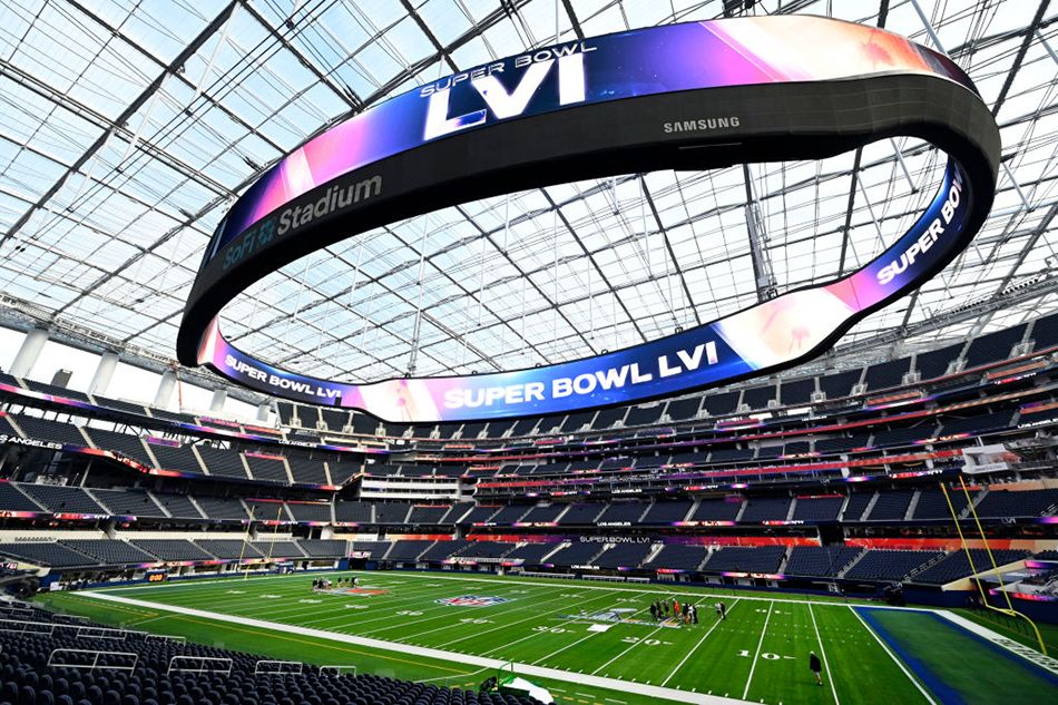 Workers prep the field at SoFi Stadium in Los Angeles for Super Bowl LVI