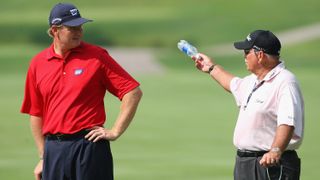 Ernie Els (L) of South Africa talks with golf coach Butch Harmon during practice for the World Golf Championship Bridgestone Invitational at Firestone Country Club July 30, 2008