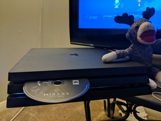 Disk being inserted into a PlayStation 4 Pro