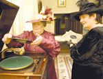 Costumed interpretors, dressed as ladies of the house, playing gramophone records, helping to recreate the atmosphere of the Victorian/Edwardian Newton House at Dinefwr Park, Llandeilo