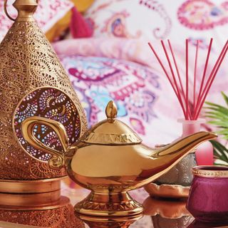 aladdin magic lamp tea pot and purple pot on table