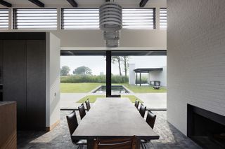 dining space in house in the fields looking out to green nature