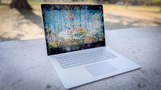 Surface Laptop 5 open on patio table running game