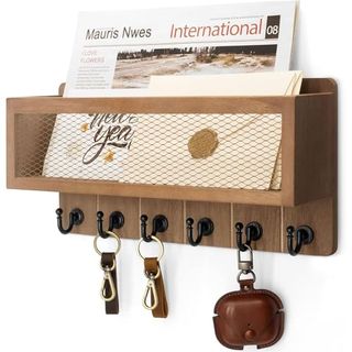 A wooden wall basket with six key hooks underneath it. Mail in the basket, a few empty keyrings on the hooks. 