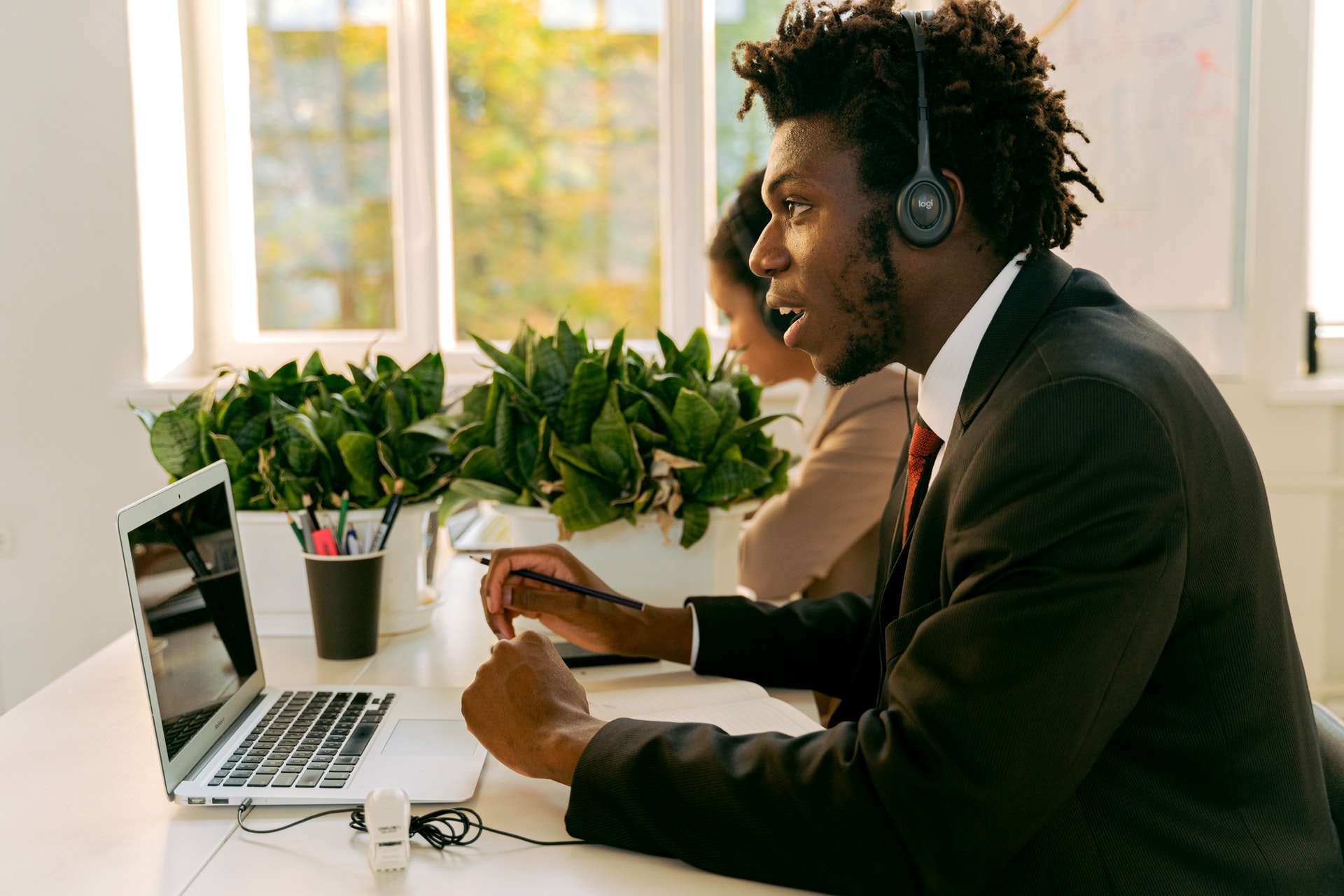 IT helpdesk administrator in Black Suit Jacket Sitting at the Table