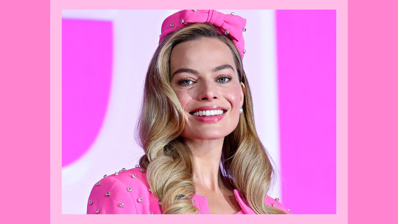 Margot Robbie&#039;s Blush: Margot pictured wearing a pink suit, with a pink makeup look and her hair in curls as she attends a press conference for &quot;Barbie&quot; on July 03, 2023 in Seoul, South Korea./ in a pink template