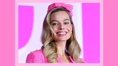 Margot Robbie's Blush: Margot pictured wearing a pink suit, with a pink makeup look and her hair in curls as she attends a press conference for "Barbie" on July 03, 2023 in Seoul, South Korea./ in a pink template