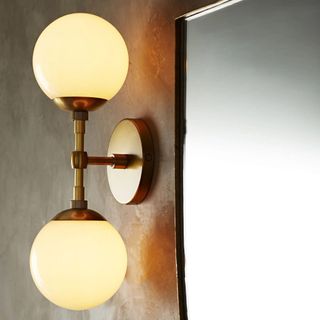 A gold wall sconce with two bulbs from ABC Home