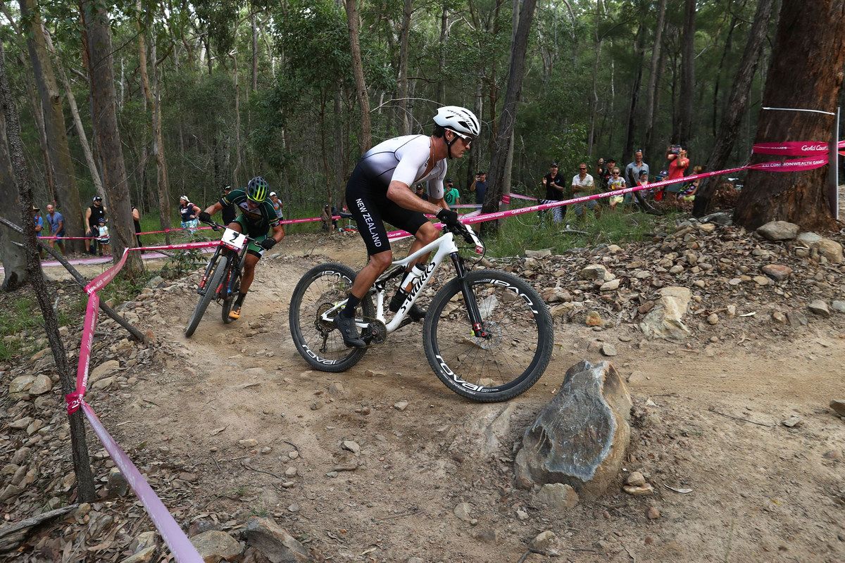 Samuel Gaze (New Zealand) riding past Alan Hatherly (South Africa) on the final lap