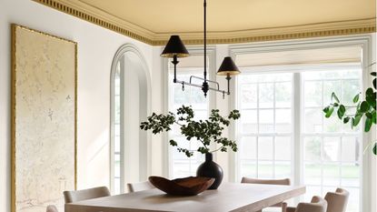 dining room with gold ceiling by joanna gaines