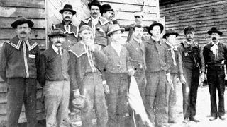 A group of Red Shirts — a white supremacist paramilitary group — poses at the polls at Old Hundred, Scotland County in North Carolina, on November 8, 1898 (Election Day). Some individuals wear pistols and white supremacy buttons.