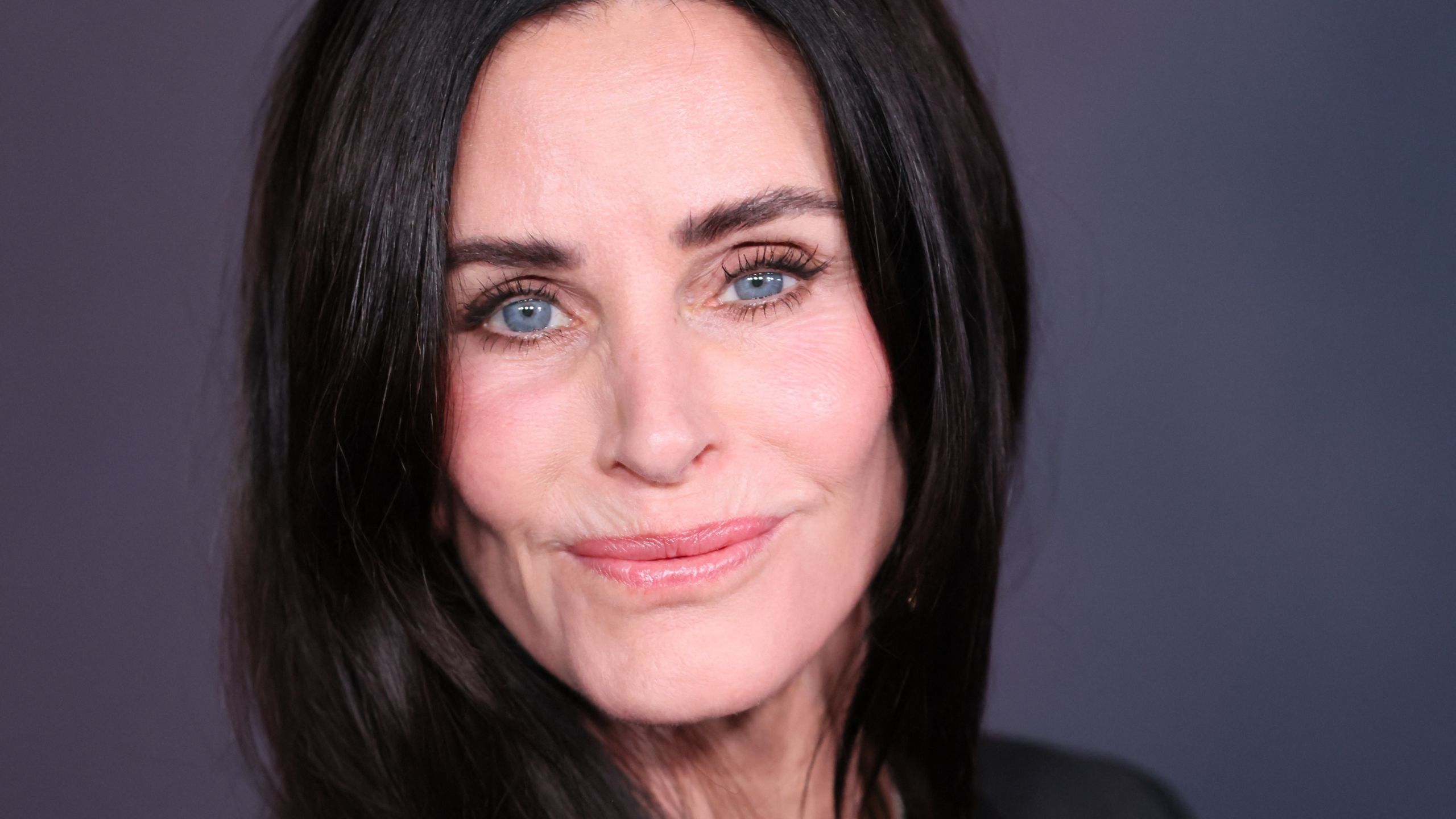 courteney cox on a navy background