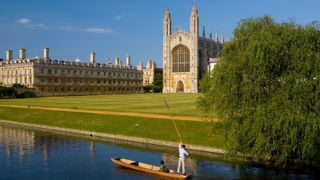 A picture of Cambridge with someone punting down the river by the University.