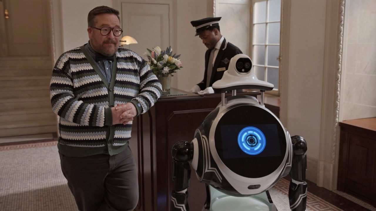 Howard standing next to L.E.S.T.R. (the robot) in Only Murders in the Building