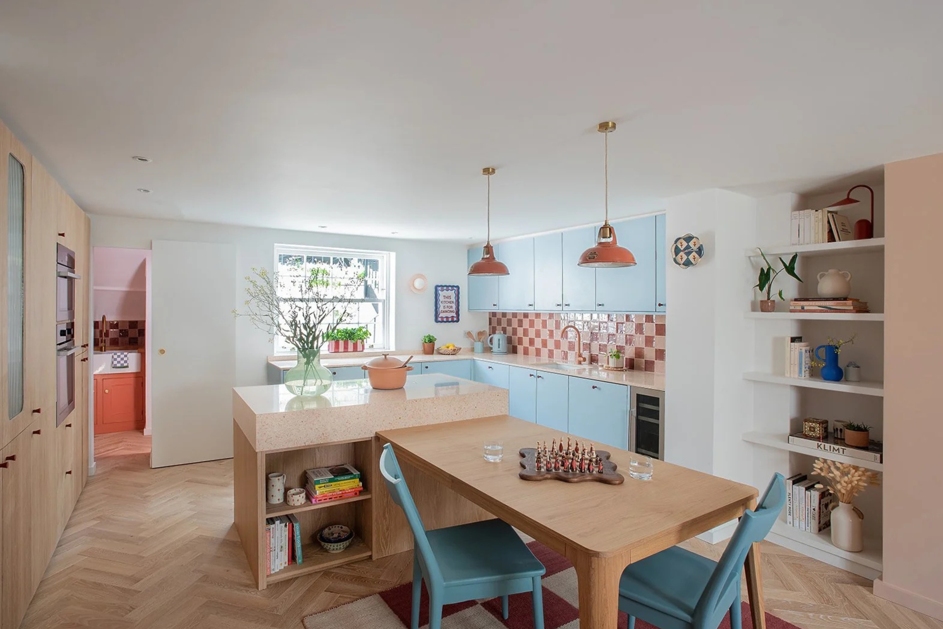 Blue kitchen with open shelving on kitchen island