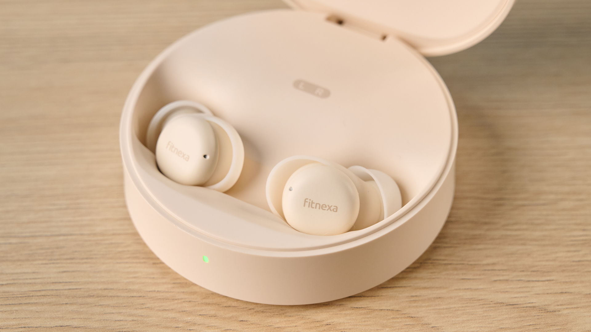A closeup of the Fitnexa SomniPods 3 ear buds in their case with the lid open