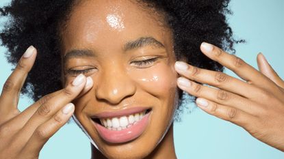 Image shows woman washing her face