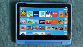 The Amazon Fire HD 10 Kids Pro on a blue surface