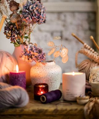 table with flower vase and scented candle