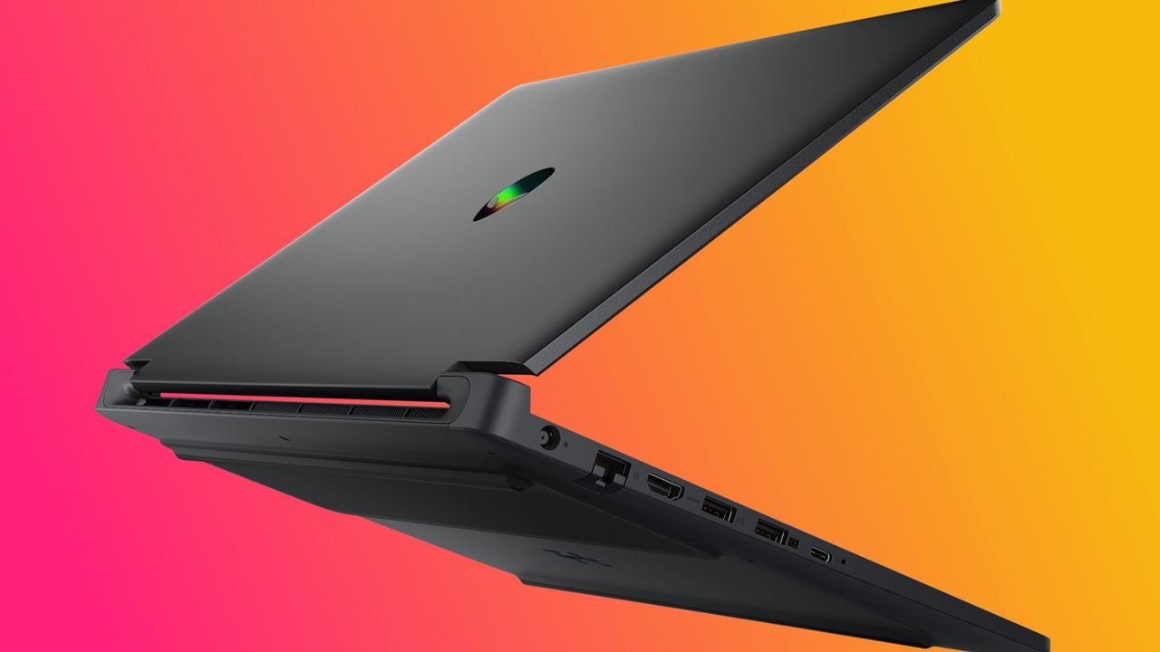 A sleek, black laptop partially open against a vibrant pink and orange gradient background. Various ports are visible, conveying a modern and tech-savvy mood.