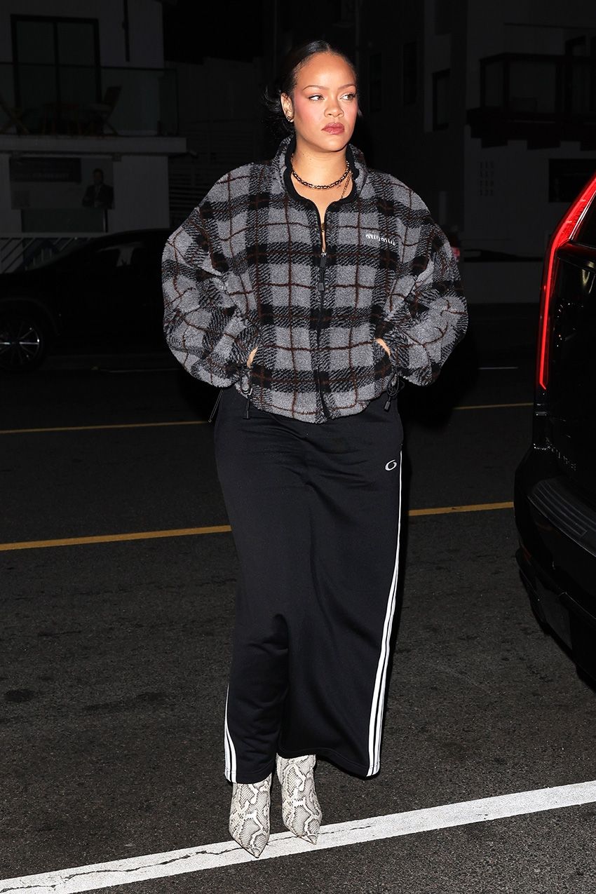 Rihanna wearing the Miu Miu Checked Teddy Jacket with track pants and snakeskin boots