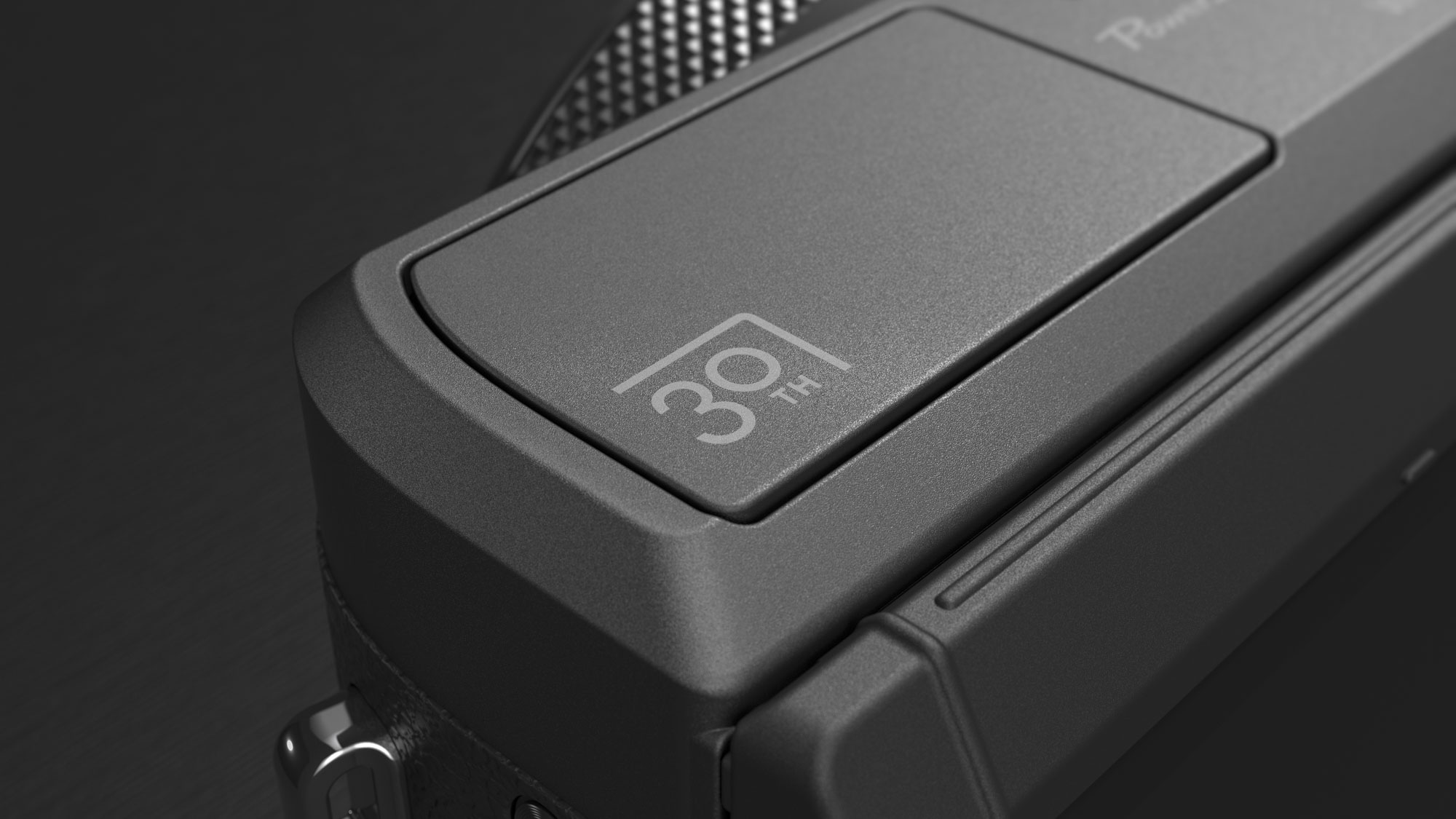 Close up of the Canon PowerShot G7 X Mark III Anniversary Edition in graphite, on a graphite-type surface