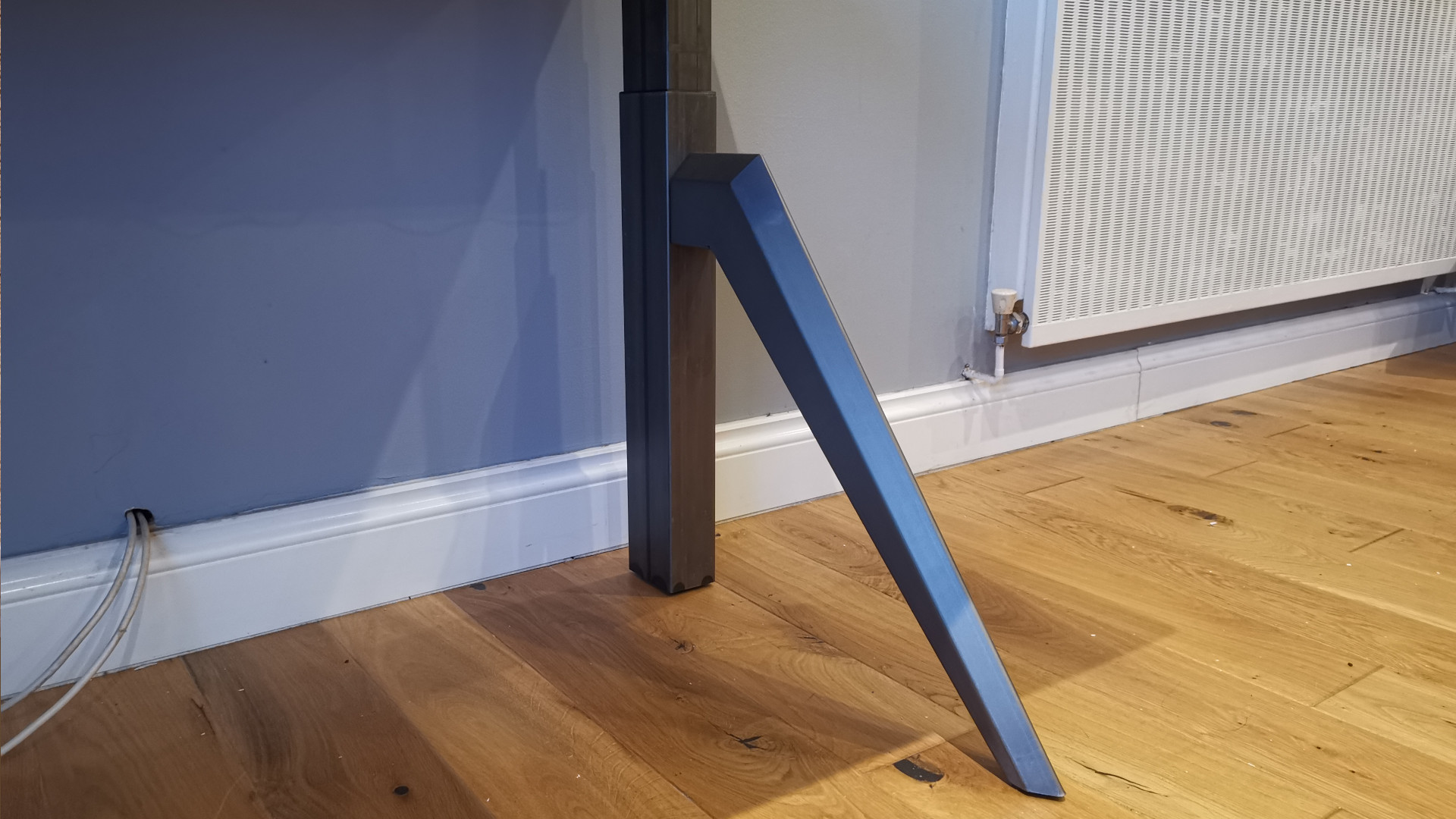 The unique industrial style legs of the Friska Primo Designer standing desk