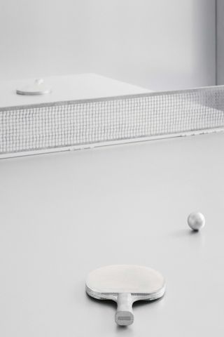 A silver room with a silver ping pong table