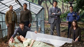 The cast of "Grimm" season 2 gathered next to Juliette (Elizabeth Tulloch) lying on the ground