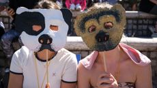 Two women protest the law by wearing dog masks