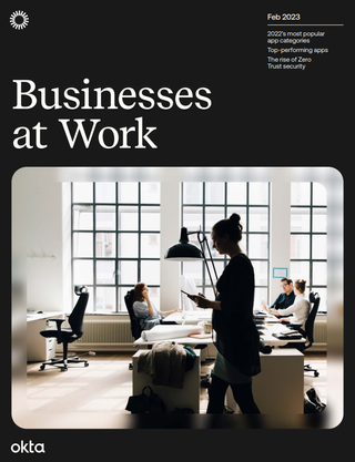 Whitepaper cover with title and Image of office space with three colleagues sat at workstations in front of a window, and female worker walking across the office with a tablet