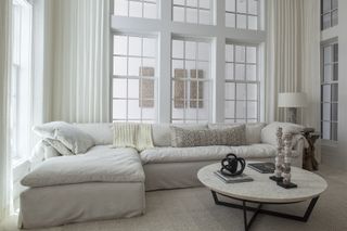 white living room with white corner sofa