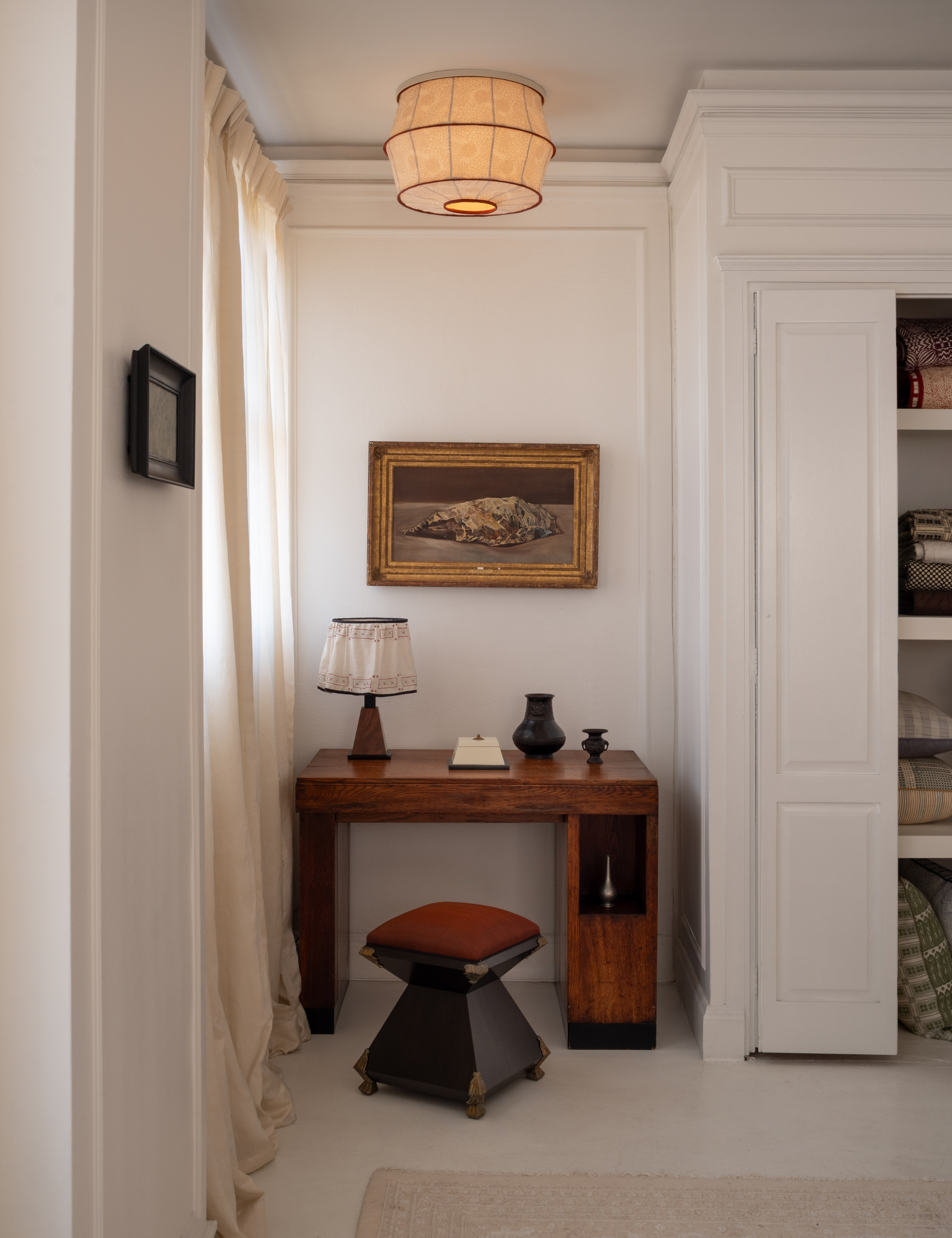 Gem Tuberose from Studio Ford's Tulip collaboration styled overhead of the office nook of a beige carpeted bedroom