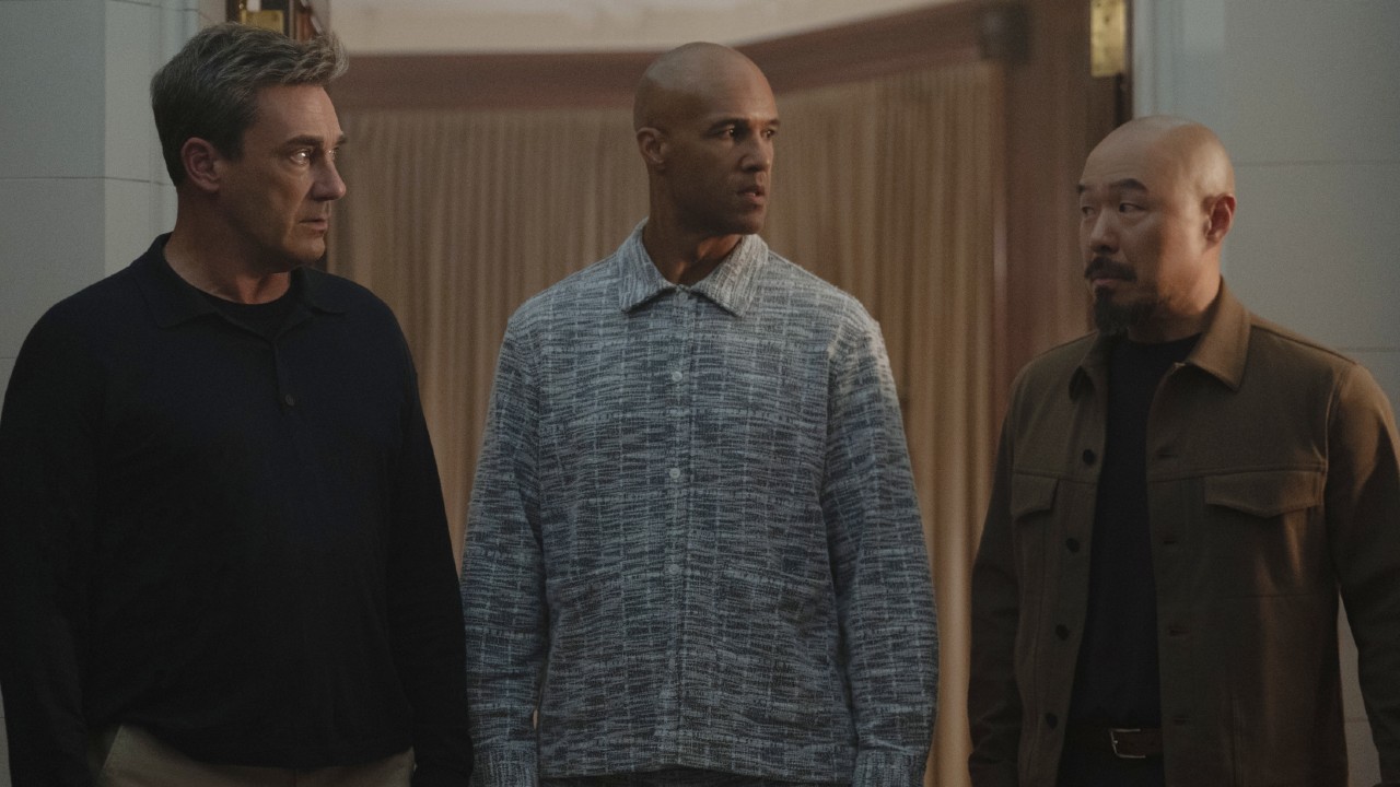 Jon Hamm, Mark Tallman and Hoon Lee looking at each other in Your Friends and Neighbors. 