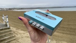 FiiO CP13 in a hand, with a Weymouth seafront backdrop