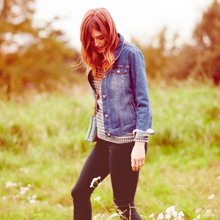 lady with jeans jacket on garden