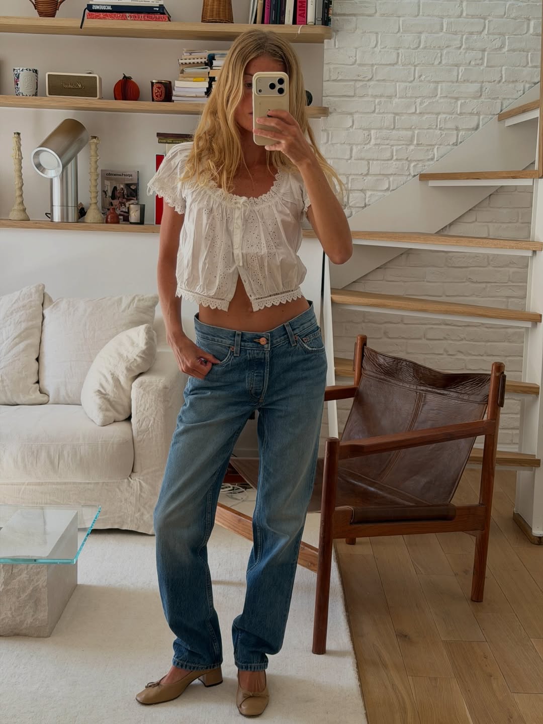 Impressive Alice Pilate is wearing a broderie anglaise top, straight jeans and heeled ballet flats.