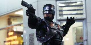 Robocop gun drawn, clearing the drug lab